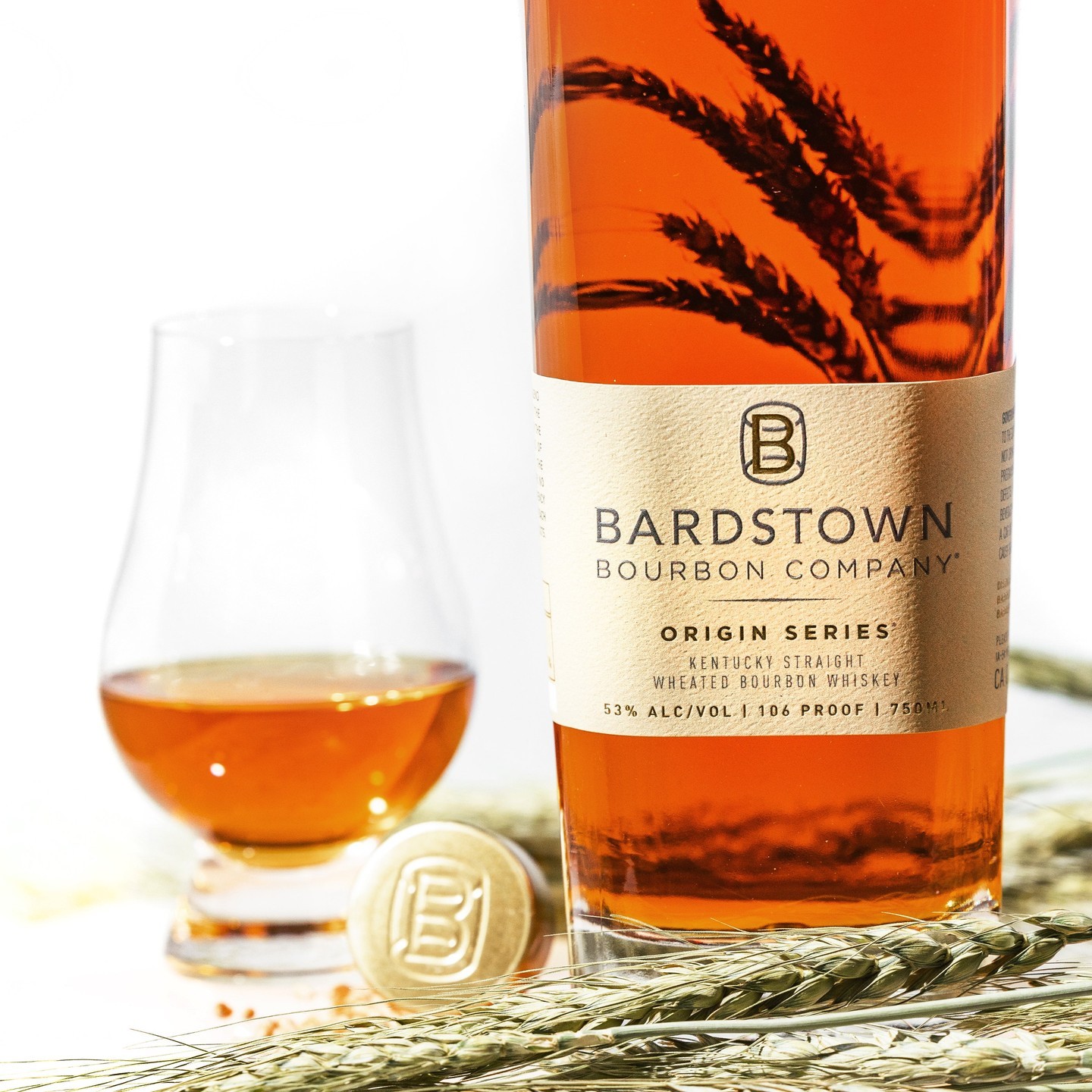 Bardstown Bourbon bottle and glass, with golden wheat and cork, highlighting the Origin Series Wheated Bourbon.